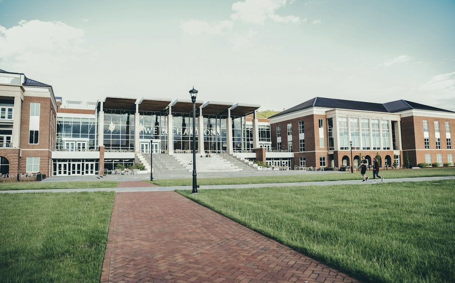 A campus lawn and academic buildings