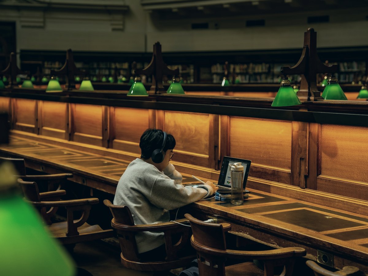 A student working alone in a university reading room