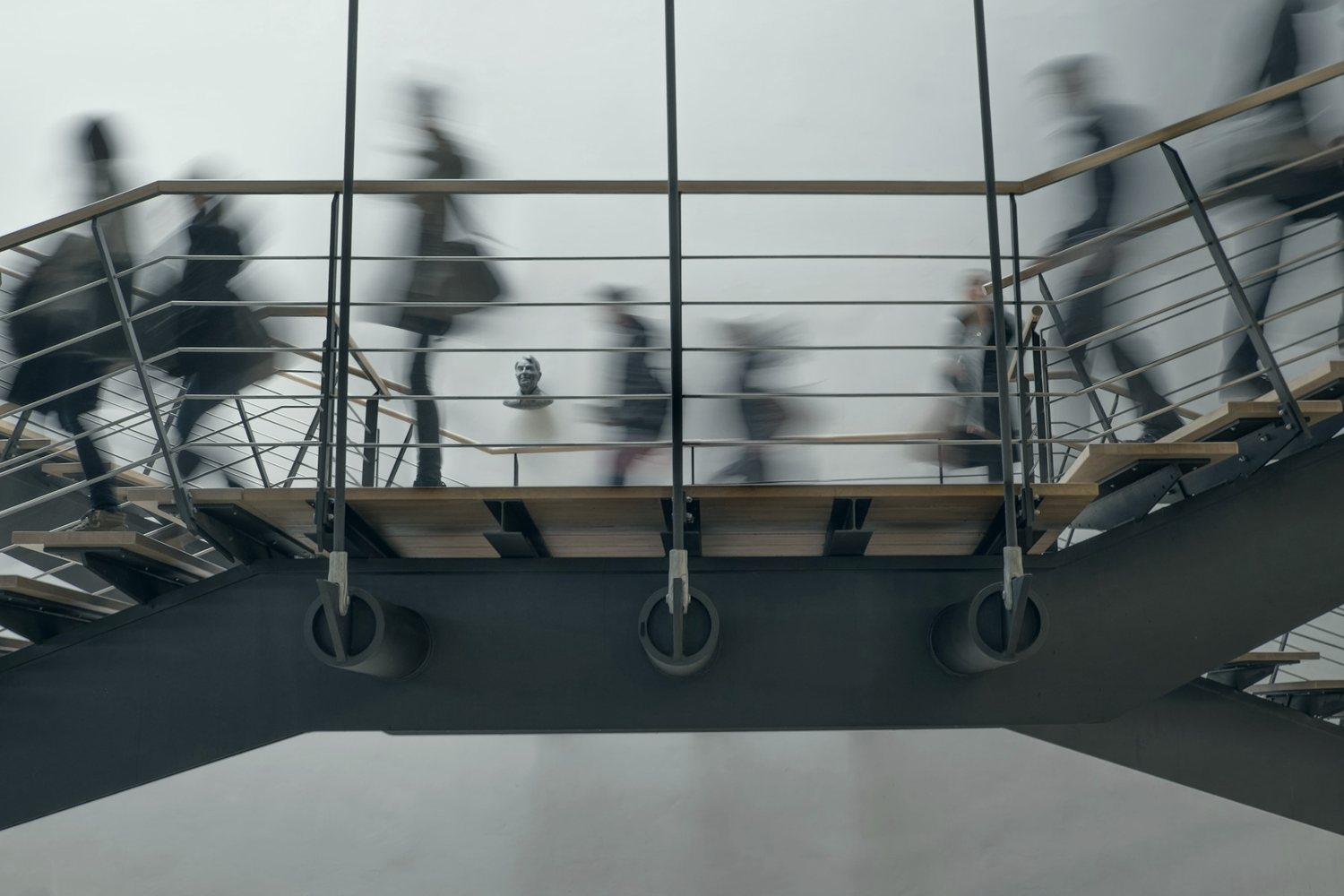 Students crossing a campus staircase between classes